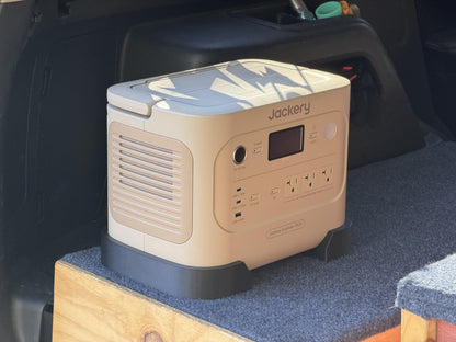 Jackery Explorer 1000 v2 locked into KodiakForged mounting rails in an SUV cargo area